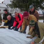 Volunteers roll out the ice rink liner at the DRA Round Top Community Ice Rink