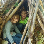 kids in a forest shelter