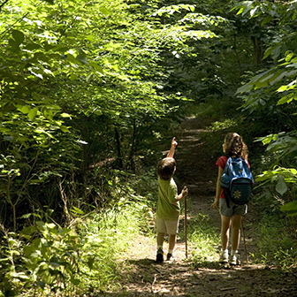 boy and girl hiking in the woods