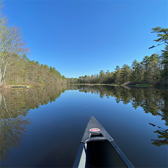 bow of a canoe on still water