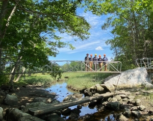 The Maine Conservation Corps crew poses for a photo on the new bridge